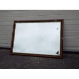 A wood framed wall mirror, approximately 70 cm x 100 cm.