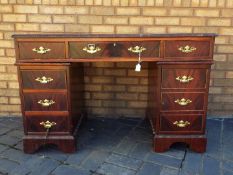 A mahogany twin pedestal desk with leather inset top,