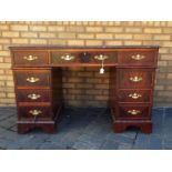 A mahogany twin pedestal desk with leather inset top,