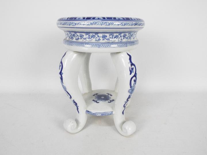 A blue and white ceramic jardiniere stan