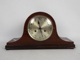 A mantel clock with Arabic numerals to a