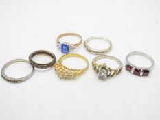 A collection of stone set rings, sizes range from K to T.