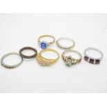 A collection of stone set rings, sizes range from K to T.