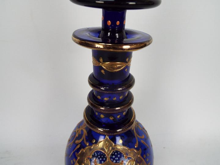 A blue glass decanter and stopper with hand painted floral and gilt decoration, - Image 3 of 3