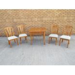 An extending dining table and four chairs,