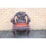 A profusely carved Chinese Dragon chair, carved dragon arms, phoenix to the backrest,