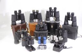 A box of various binoculars, part cased.
