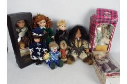 A collection of porcelain dressed dolls and similar.