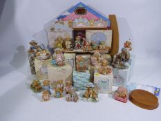 A Cherished Teddies display stand and a collection of predominantly boxed Cherished Teddies.