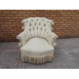 An upholstered armchair.