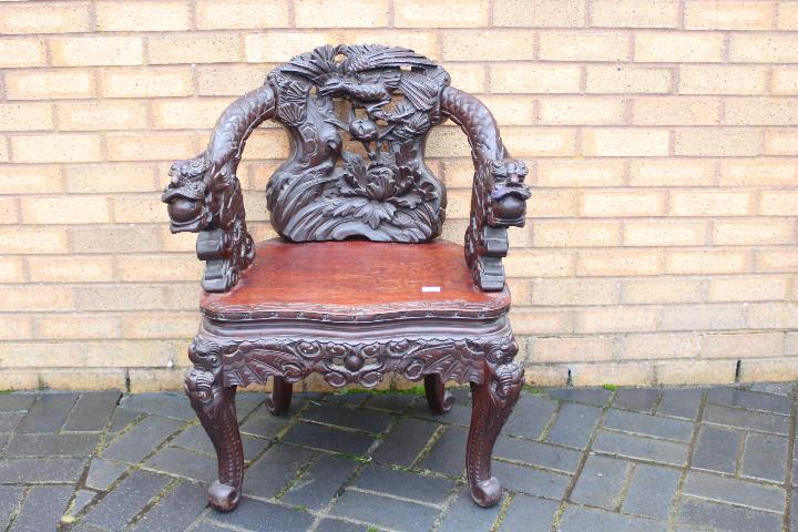 A profusely carved Chinese Dragon chair, carved dragon arms, phoenix to the backrest, - Image 4 of 4