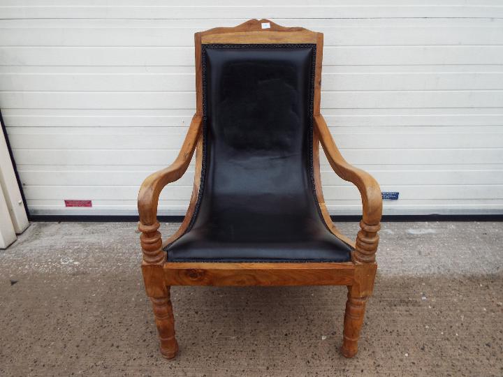 A good quality wood framed low armchair.