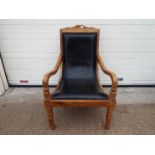 A good quality wood framed low armchair.