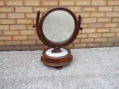 A circular, wood framed toilet mirror, approximately 60 cm (h).