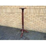 A mahogany torchere with twist column on