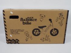 A boxed Indi balance bike # 412232.