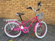 A pink girl's bike with 20" wheels.