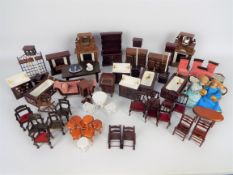 Unmarked - A quantity of dolls house furniture including a three piece suite,