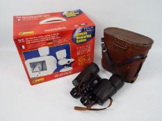 A boxed wireless camera monitoring system and a cased pair of binoculars.