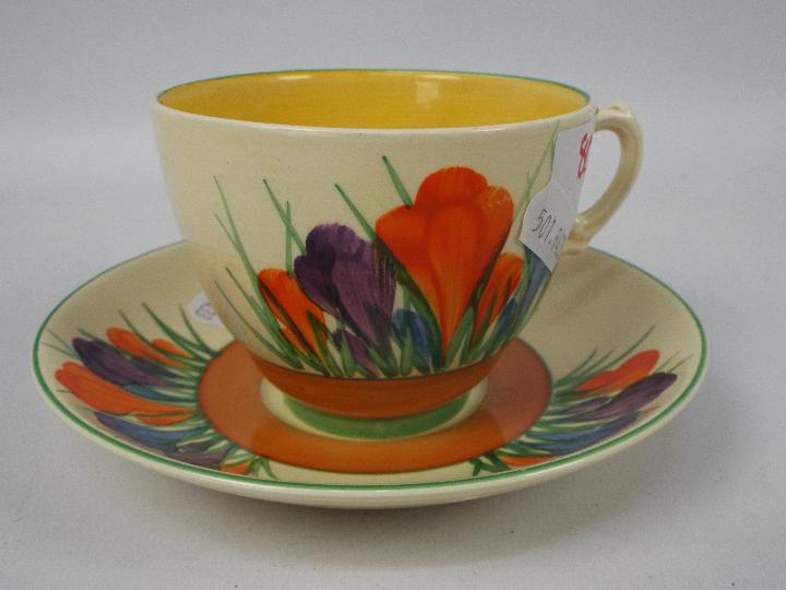 Clarice Cliff - a teacup and saucer hand painted in the Crocus pattern, Clarice Cliff, - Image 2 of 5