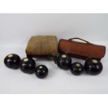 A collection of bowls and an antique foot stool.