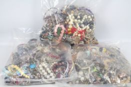 Costume Jewellery - Three clear, sealed bags of unsorted costume jewellery, approximately 13kg.