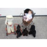 A group of vintage soft toys, a modern doll and ornamental Victorian styled pram.