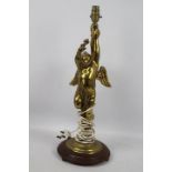 A gilt metal table lamp in the form of a putto, approximately 56 cm (h).