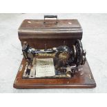 A vintage Jones sewing machine in wooden case