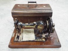 A vintage Jones sewing machine in wooden case