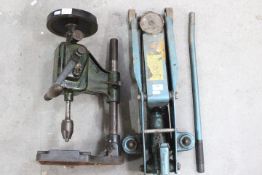 A vintage pillar drill and a jack.
