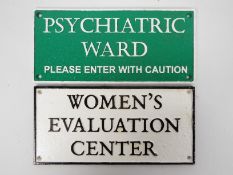 Two cast iron wall signs, Women's Evalua