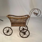 A wicker dolls' pram. NOTE: ITEM IS LOCATED IN THE L34 POSTCODE AREA.