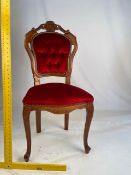 An upholstered chair with carved decoration. NOTE: ITEM IS LOCATED IN THE L34 POSTCODE AREA.