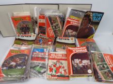 Manchester United - A large quantity of programmes, 1970's and later, one box and two binders.