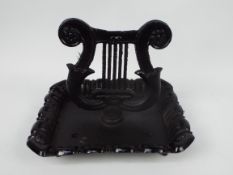 A cast iron boot scraper in the form of