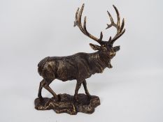 A bronzed, cast iron, model of a stag, approximately 43 cm (h). XSTAN.