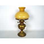 A vintage brass oil lamp with glass shade, approximately 41 cm (h).