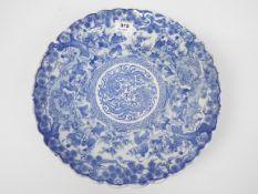 A blue and white shallow dish with shaped rim,