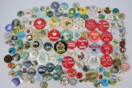 A collection of vintage pin badges, pred
