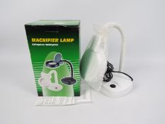 A boxed desktop magnifier lamp.