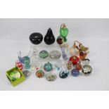 A varied collection of paperweights and glassware.
