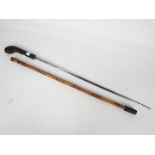 A 20th century bamboo swordstick with leather bound hilt and blade marked Toledo,