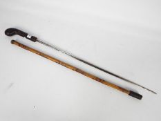 A 20th century bamboo swordstick with leather bound hilt and blade marked Toledo,