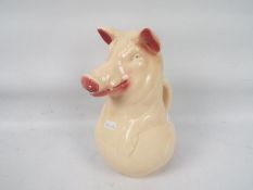 A French majolica jug by Sarreguemines, modelled in the from of a pig, approximately 24 cm (h).