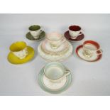 Susie Cooper - A collection of tea wares to include three Magnolia pattern tea cups and saucers and