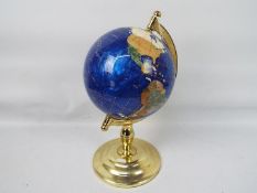 A gemstone terrestrial globe on brassed stand,