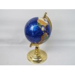 A gemstone terrestrial globe on brassed stand,