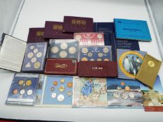 A collection of uncirculated and circulated coins in wallets (and similar) of which 12 sets
