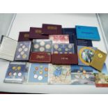 A collection of uncirculated and circulated coins in wallets (and similar) of which 12 sets